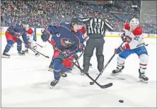  ?? [BARBARA J. PERENIC/DISPATCH] ?? Blue Jackets defenseman Markus Nutivaara and Montreal’s Nicolas Deslaurier­s go after the puck during the second period Monday night in Nationwide Arena.