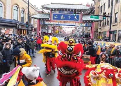  ?? ?? ABOVE: The Chinatown Lunar New Year parade kicked off Sunday on Wentworth Avenue and headed north from 24th Street to Cermak Road. Organizers estimated that 30,000 people would attend.