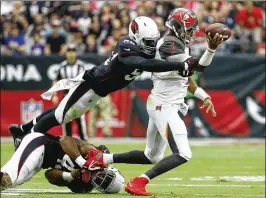  ?? AP ?? Bucs QB Jameis Winston (right) suffered a sprained AC joint in his passing shoulder on this play Sunday at Arizona. He hasn’t been ruled out for this week’s game at Buffalo.