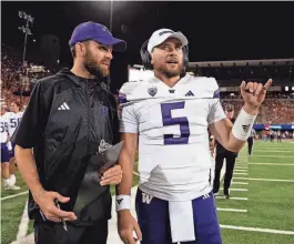  ?? SPENCER KLEIN/UW ?? Taylor Pope, left, converses with Washington Huskies quarterbac­k Dylan Morris ahead of Monday’s national title football game between Washington and Michigan at NRG Stadium in Houston.