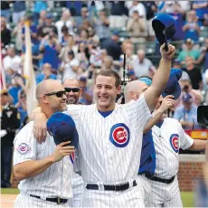  ?? ASSOCIATED PRESS/ NAM Y. HUH ?? Chicago Cubs David Ross, left, and Anthony Rizzo celebrate the team’s NL Central Division title on Friday.