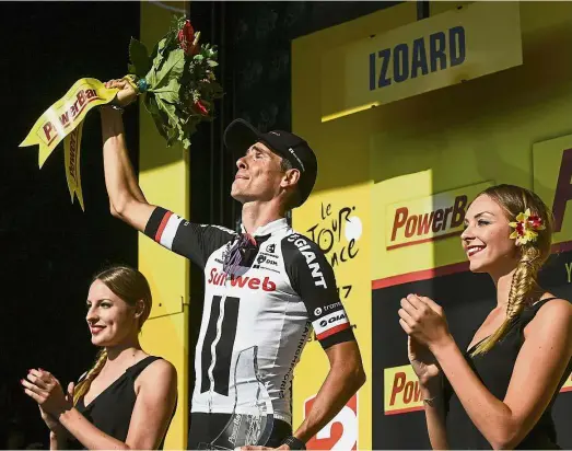  ?? — AFP ?? Sweet taste of victory: France’s Warren Barguil celebrates on the podium after winning Stage 18 of the Tour de France on Thursday.