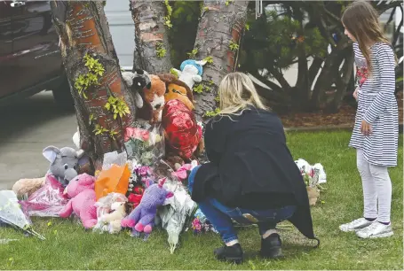  ?? ED KAISER ?? Neighbours add to the growing memorial for Bella Rose Desrosiers, 7, on the front lawn of her home Wednesday. A friend of the girl’s mother is facing second-degree murder charges in her death. Police said Friday the suspect was experienci­ng mental health concerns before the incident.