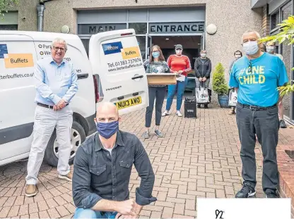  ??  ?? Aaron Dowds, front, with SNP MP Douglas Chapman, left, and other volunteers at the Vine Church.