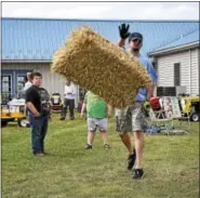  ??  ?? Among the many activities at the event was the popular hay bale toss.