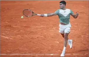  ?? (AFP) ?? Spain’s Carlos Alcaraz Garfia plays a forehand return to Italy’s Flavio Cobolli during their men’s singles match on day two of French Open at the Court Suzanne-Lenglen in Paris on Monday.