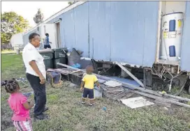  ?? Laura SKELDING / AMERICAN-STATESMAN ?? Ethel Wright, 65, of Kyle is raising her daughter’s four children on her own. With her in the yard of her run-down trailer are Makhia and Michael Foster, both 2, and Virgil ‘Petey’ Crawford, 8. Donations are coming in that will help Wright with her...