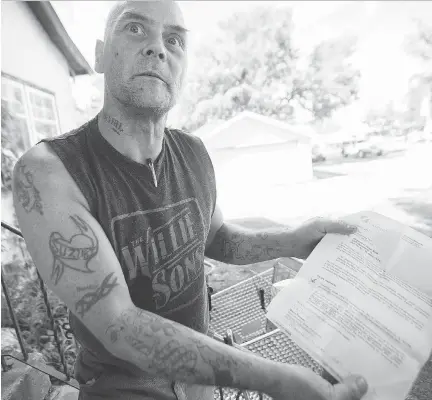  ?? KAYLE NEIS ?? Sheldon Tarry shows a letter ordering his landlord to remove an illegal suite from the basement of the house where he lives off Idylwyld Drive. Tarry’s downstairs neighbours are causing concerns in the neighbourh­ood and now he too faces eviction...