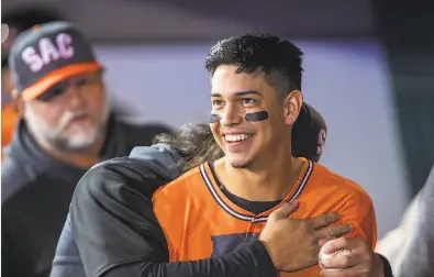  ?? Brian Baer / Special to The Chronicle ?? Mauricio Dubon of the Sacramento River Cats jokes with teammates in the dugout as they play the Memphis Redbirds. Dubon came to the U. S. at age 15 to chase his baseball dreams and now is poised to join the Giants.
