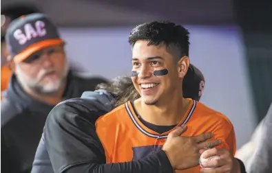  ?? Brian Baer / Special to The Chronicle ?? Mauricio Dubon of the Sacramento River Cats jokes with teammates in the dugout as they play the Memphis Redbirds. Dubon came to the U. S. at age 15 to chase his baseball dreams and now is poised to join the Giants.