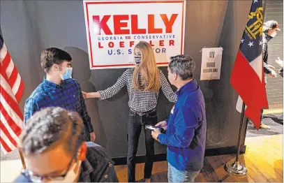  ?? Ben Gray The Associated Press ?? U.S. Sen. Kelly Loeffler, R-GA., talks to supporters Thursday during a campaign event at Mccray’s Tavern in Marietta, Ga.