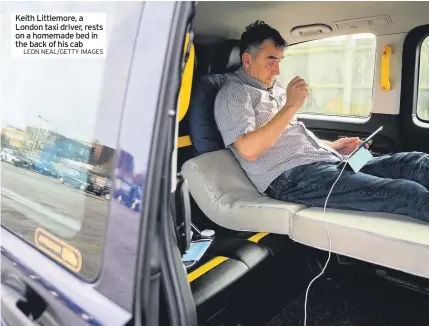  ?? LEON NEAL/GETTY IMAGES ?? Keith Littlemore, a London taxi driver, rests on a homemade bed in the back of his cab