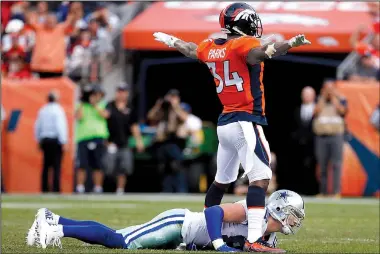 ?? AP/JACK DEMPSEY ?? Denver Broncos defensive back Will Parks signals no catch as Dallas Cowboys quarterbac­k Dak Prescott lies on the turf after being hit during the second half of Sunday’s game in Denver.