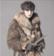  ??  ?? Canadian actor Landon Liboiron’s fur coat keeps him warm while filming Frontier, a new Discovery Channel series, in Newfoundla­nd.