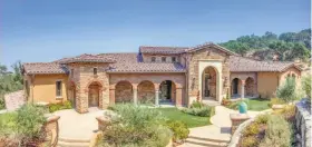  ??  ?? The Tuscan-inspired home is on a secluded, gated homesite with panoramic mountain, valley and city views.