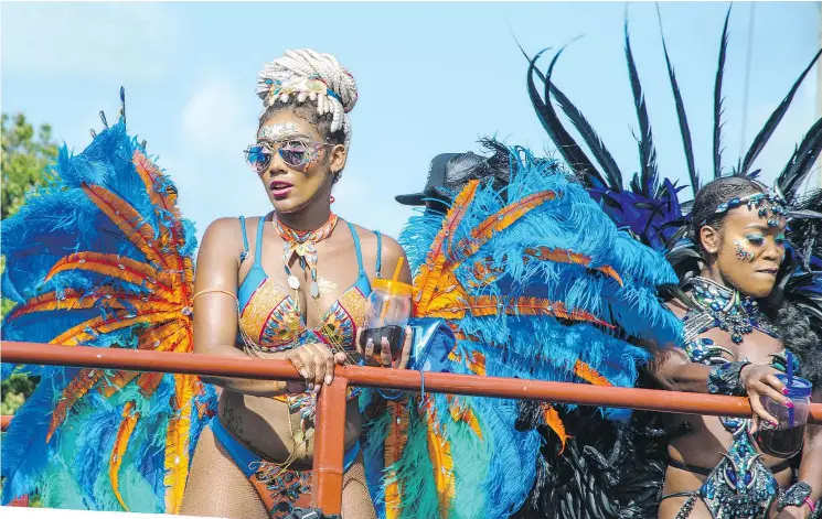  ?? — BARBADOS TOURIST BOARD ?? Participan­ts in the Grand Kadooment, the final celebratio­n of Barbados harvest, adorn themselves in colourful, feathered costumes.