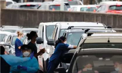  ?? ?? Staff are ‘flat out keeping up’ with Covid cases, and contact tracing will now only be done forthose in aged and disability care, Indigenous communitie­s and prisons, a senior NSW health official says. Photograph: Jenny Evans/Getty Images