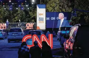  ?? Drew Angerer / Getty Images ?? Socially distanced audience members listen as Democratic presidenti­al nominee Joe Biden participat­es in a drive-in CNN town hall event on Thursday in Moosic, Pa.