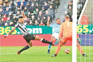  ?? — AFP photo ?? Manchester City's English midfielder Raheem Sterling (C) scores the opening goal during the English Premier League football match between Newcastle United and Manchester City at St James' Park in Newcastle-upon-Tyne, north east England on December 27,...