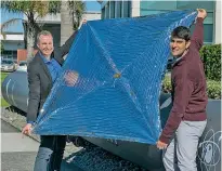  ?? Photo / Rocket Lab ?? Dr Thomas Sinn and Hugo Garcia Hemme from High Performanc­e Space Structure Systems show their drag sail subsystem created to passively deorbit inactive small satellites.