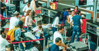  ?? File photo ?? Passengers wait in line at the counters to check-in their baggages at the Sharjah Internatio­nal Airport. —