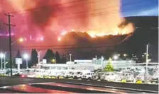  ?? NICOLE RITTER VIA REUTERS ?? Flames rise as a wildfire burns on a hill in Kamloops, British Columbia on Canada Day. An extended heat wave is fuelling wildfires which have started a week earlier than in 2017.