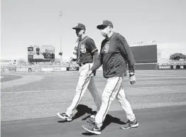 ?? K.C. ALFRED U-T ?? Padres starter Blake Snell and pitching coach Larry Rothschild walk in from the bullpen. Snell wants to go longer in his starts this season.