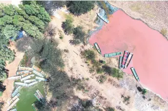  ?? — AFP fphotos ?? Aerial view of stranded boats in a channel that was closed off by dry conditions in Lake Cuitzeo at the Mariano Escobedo community, Michoacan State, Mexico.