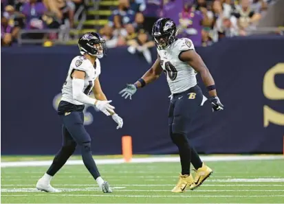  ?? KAUFMAN/AP TYLER ?? Ravens safety Kyle Hamilton, left, and outside linebacker Justin Houston celebrate during a game against the Saints in New Orleans on Nov. 7. Hamilton, a first-round draft pick, has come on strong as defensive coordinato­r Mike Macdonald figures out how to use his skill set.