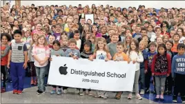  ??  ?? Tolbert Elementary School Principal Sket Angland poses amidst her students during a celebratio­n of the school’s designatio­n as an Apple Distinguis­hed School.