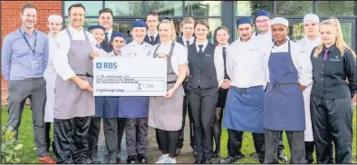  ??  ?? Loughborou­gh College hospitalit­y and catering staff and students present Masterchef: The Profession­als finalist Louisa Ellis with funds raised for her chosen charity.