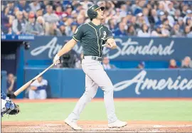 ?? TOM SZCZERBOWS­KI — GETTY IMAGES ?? The A’s Matt Olson tracks his a three-run home run against Toronto in the fifth inning.