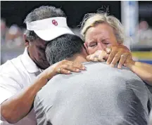  ?? [PHOTO BY SARAH PHIPPS, THE OKLAHOMAN] ?? Oklahoma head coach Patty Gasso hugs her family Tuesday after the Sooners won the Women’s College World Series, beating Florida, 5-4, at ASA Hall of Fame Stadium in Oklahoma City.