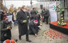  ?? Maja Hitij / Getty Images ?? People place flowers outside the Austrian Embassy in Berlin in memory of the victims of Monday’s terror attack in Vienna.