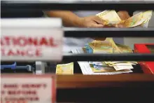  ?? Reuters ?? A teller counts Philippine peso bills at a money remittance centre in Makati City, Philippine­s. Remittance­s to Asia Pacific are an important source of income for families.