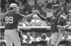  ?? John Peterson/Associated Press ?? Oklahoma pitcher Trevin Michael, left, and catcher Jimmy Crooks are trying to join their softball counterpar­ts in winning a national title.