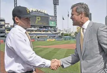  ?? Matt Freed/Post-Gazette ?? Pirates president Frank Coonelly greets first-round draft pick Travis Swaggerty on June 15 at PNC Park.