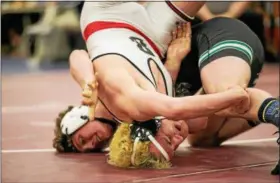  ?? NATE HECKENBERG­ER — FOR DIGITAL FIRST MEDIA ?? Boyertown’s Jacob Miller tries to roll away from Pennridge’s Josh Stillings before getting pinned in the 182-pound final.