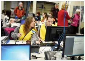  ?? Herald photo by Tijana Martin ?? Kelli Tuttle, left, and Clayton Varjassy participat­e in a training exercise for the Town of Coaldale's Emergency Operations Centre and Emergency Management Agency on Thursday.