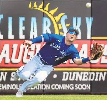  ?? FRED THORNHILL THE CANADIAN PRESS ?? Toronto’s Daulton Varsho makes a diving catch during Sunday’s game against the Philadelph­ia Phillies in Dunedin, Fla. The Jays won, 16-4.