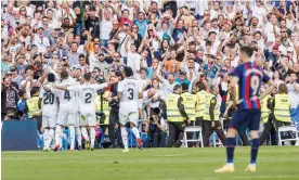  ?? Photograph: DAX Images/NurPhoto/Shuttersto­ck ?? Real Madrid’s Federico Valverde celebrates with his teammates as Barcelona’s Robert Lewandowsk­i watches on.