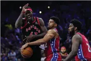  ?? MATT SLOCUM — THE ASSOCIATED PRESS ?? Toronto Raptors’ Pascal Siakam, left, can’t get past the Sixers’ Tobias Harris, center, and Joel Embiid during the first half of Game 2Monday night at Wells Fargo Center.