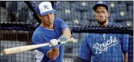  ?? AP/CHARLIE RIEDEL ?? Kansas City pitcher Jeremy Guthrie takes a few swings in the batting cage as James Shields watches. Shields will get the start for the Royals on Tuesday in Game 1 of the World Series.