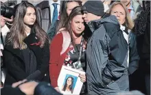  ?? JACQUELYN MARTIN THE ASSOCIATED PRESS ?? Lori Alhadeff, centre, is comforted at a news conference by husband Ilan Alhadeff as she holds a photo of their daughter, Alyssa Alhadeff, 14, who was killed in the shootings at Marjory Stoneman Douglas High School.