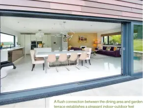  ??  ?? A flush connection between the dining area and garden terrace establishe­s a pleasant indoor-outdoor feel