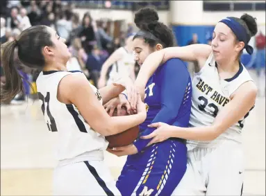  ?? Peter Hvizdak / Hearst Connecticu­t Media ?? East Haven’s Isabella Ragaini, left, and teammate Taylor Salato, right, tie up Mercy’s Vienna Knox on Monday.