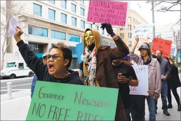  ?? Dania Maxwell Los Angeles Times ?? SINAKHONE KEODARA, left, chants in a picket line with ride-hailing drivers in Los Angeles in January.