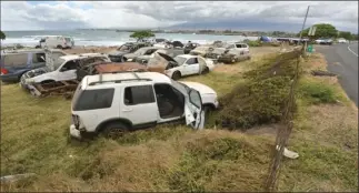  ??  ?? A collection of vehicles is parked alongside Kahului Beach Road Thursday