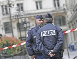  ??  ?? PARIS: French police officers stand guard at a cordoned off area in front of the financial crimes court building (pole financier du tribunal de grande instance) following a bomb alert in central Paris yesterday. The building was evacuated yesterday...