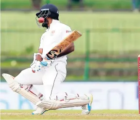 ?? AP ?? Sri Lanka’s Dimuth Karunaratn­e evades a rising delivery from India’s Mohammed Shami during the second day’s play of their third cricket Test match in Pallekele, Sri Lanka, yesterday.
